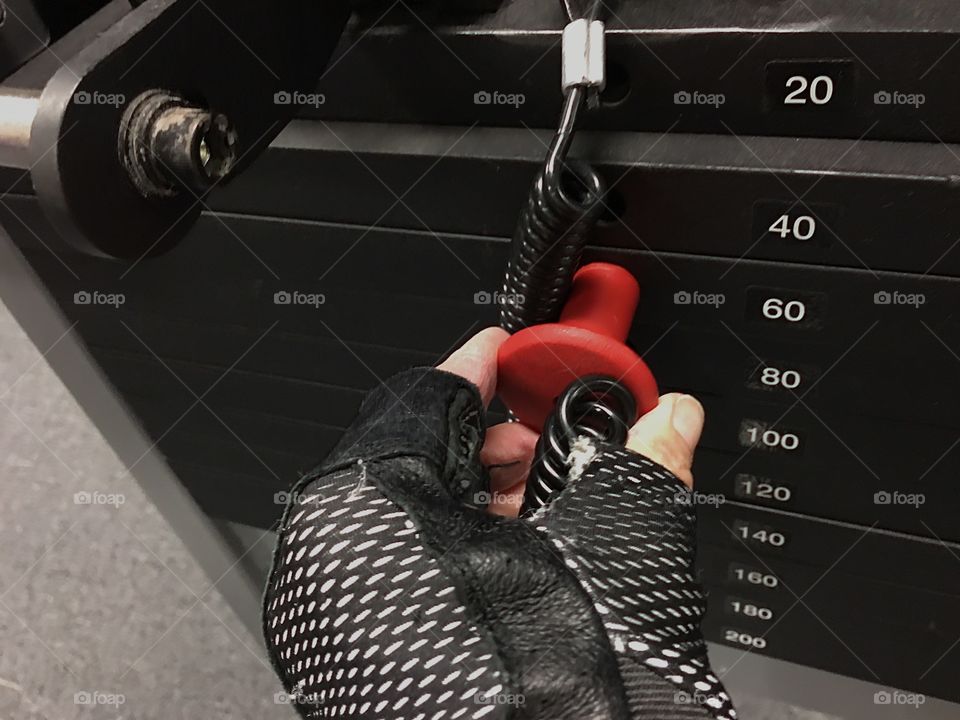 Working out with a weight machine at home.