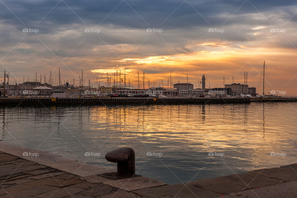 Sunset over large port