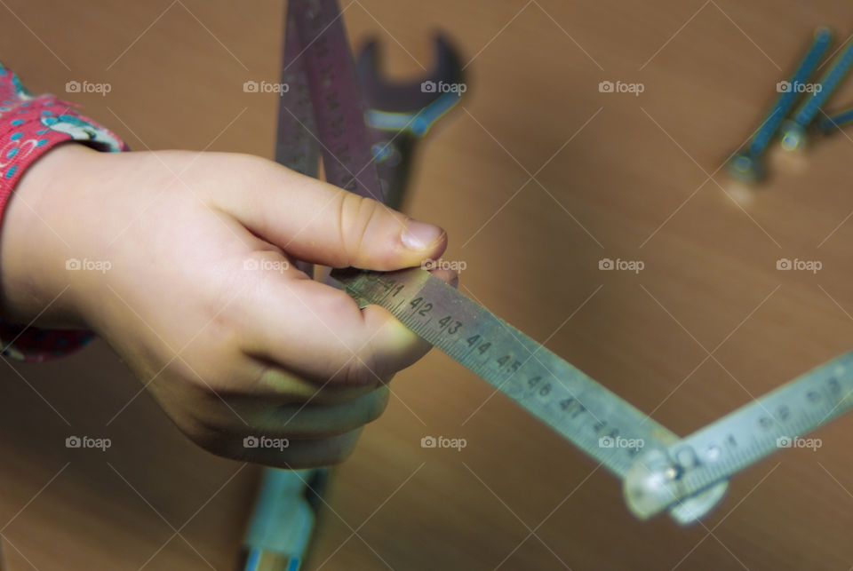 little girl holding tools