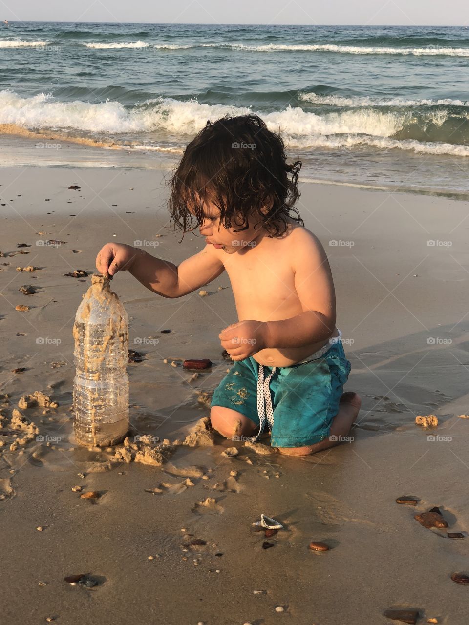 Toddler playing on the beach 