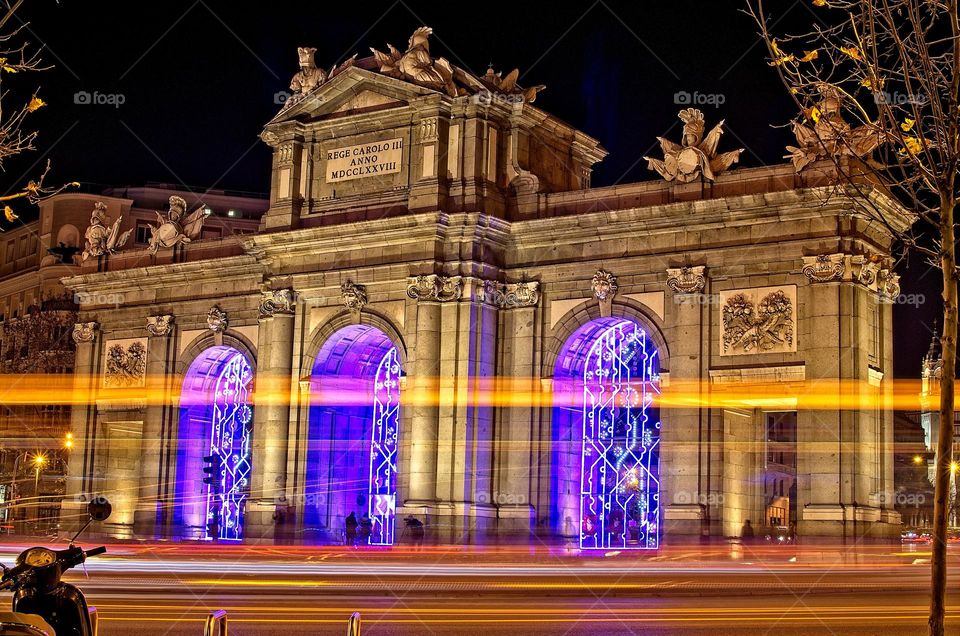 Traffic light trails in front of the Puerta de Alcalá in Madrid 