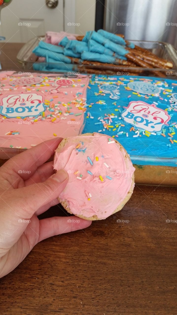 holding a gender reveal cookie