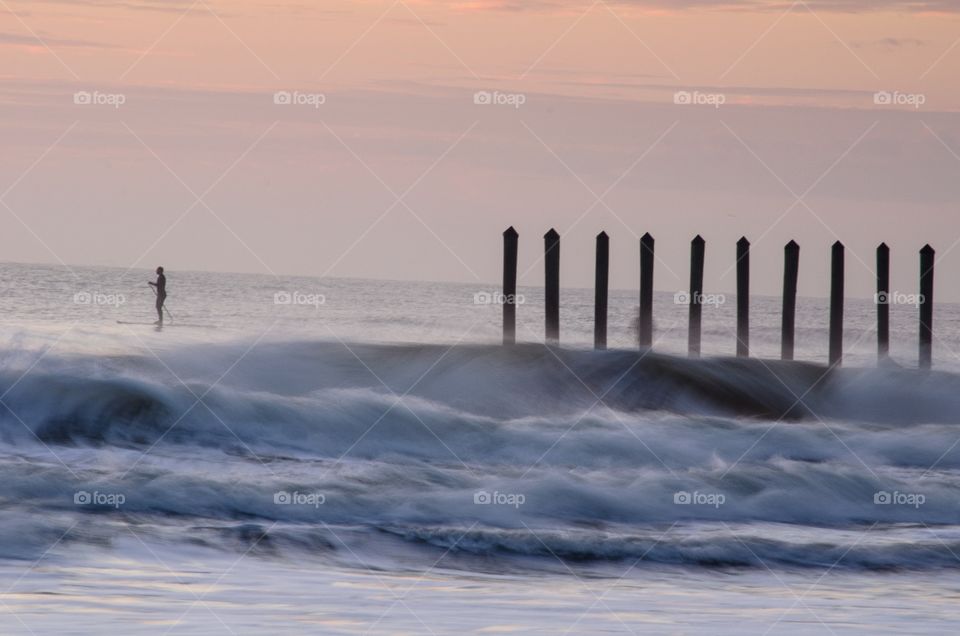 After rising early to take some beach sunrise photos, I noticed a lone surfer silhouetted against the morning sky.