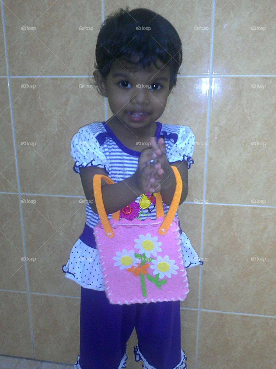 Little girl happily holding a Craft Bag