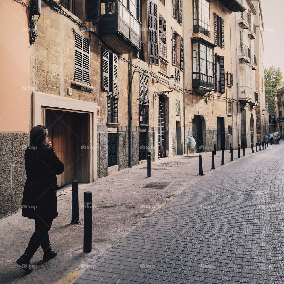 Woman walking through old town 