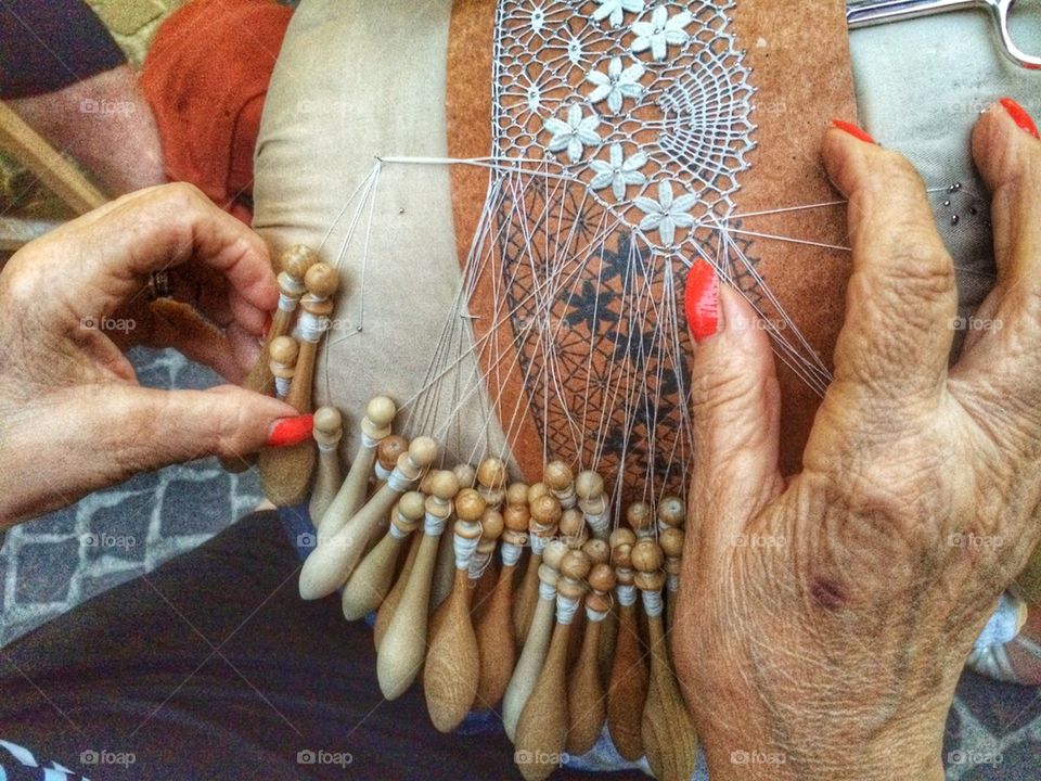 Close-up of hand making lace