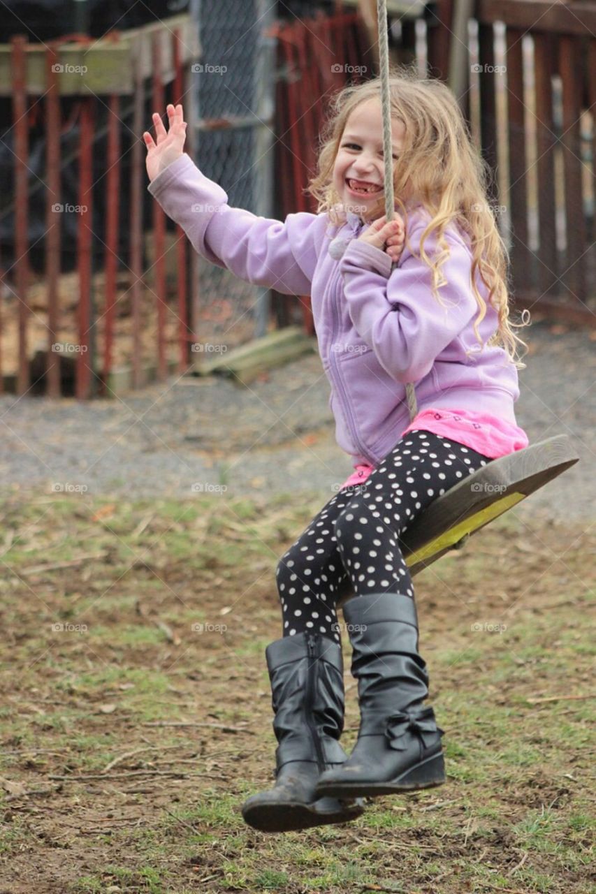 Girl having fun on swings at playground