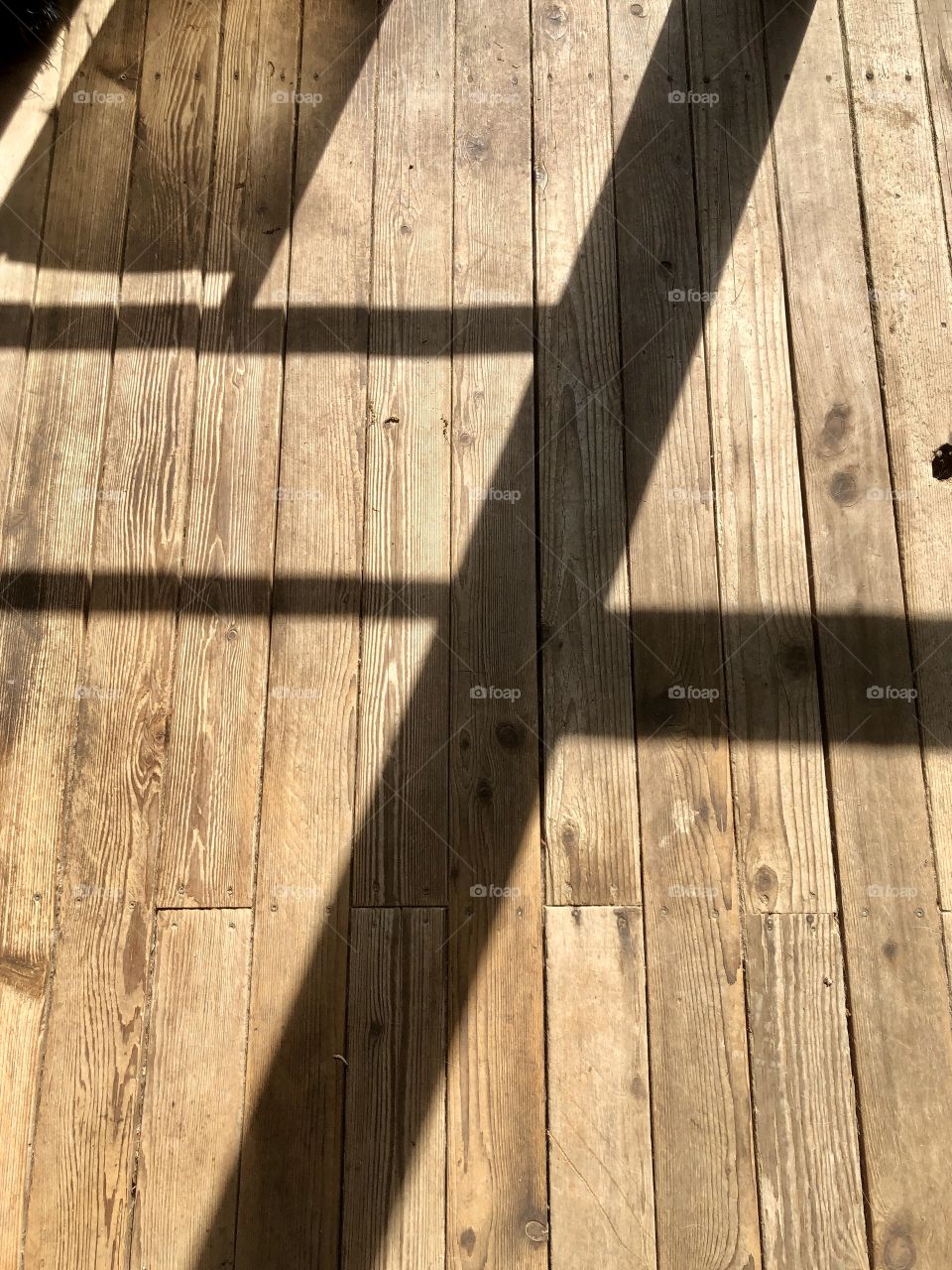Sun and shadows on wooden floor 