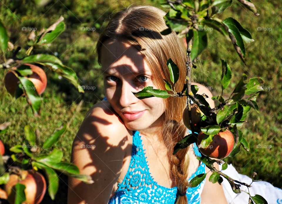 young pretty blonde woman in the apple garden