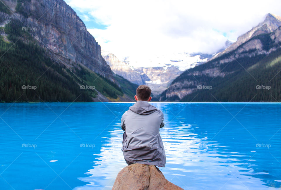 Sitting on a rock looking over Lake Louise. 