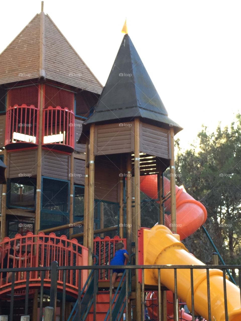 Kid climbing colorful play structure