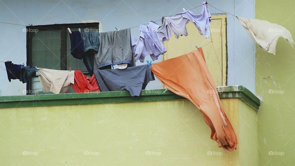 Family laundry being dried on a terrace  balcony 
clothes line in Hyderabad , India.