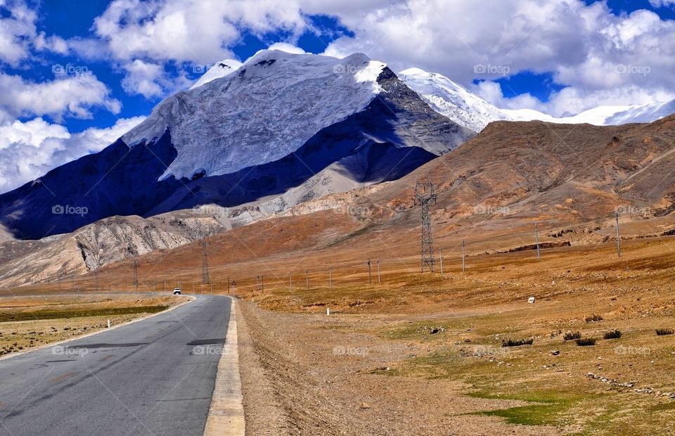 Road passing by the mountains