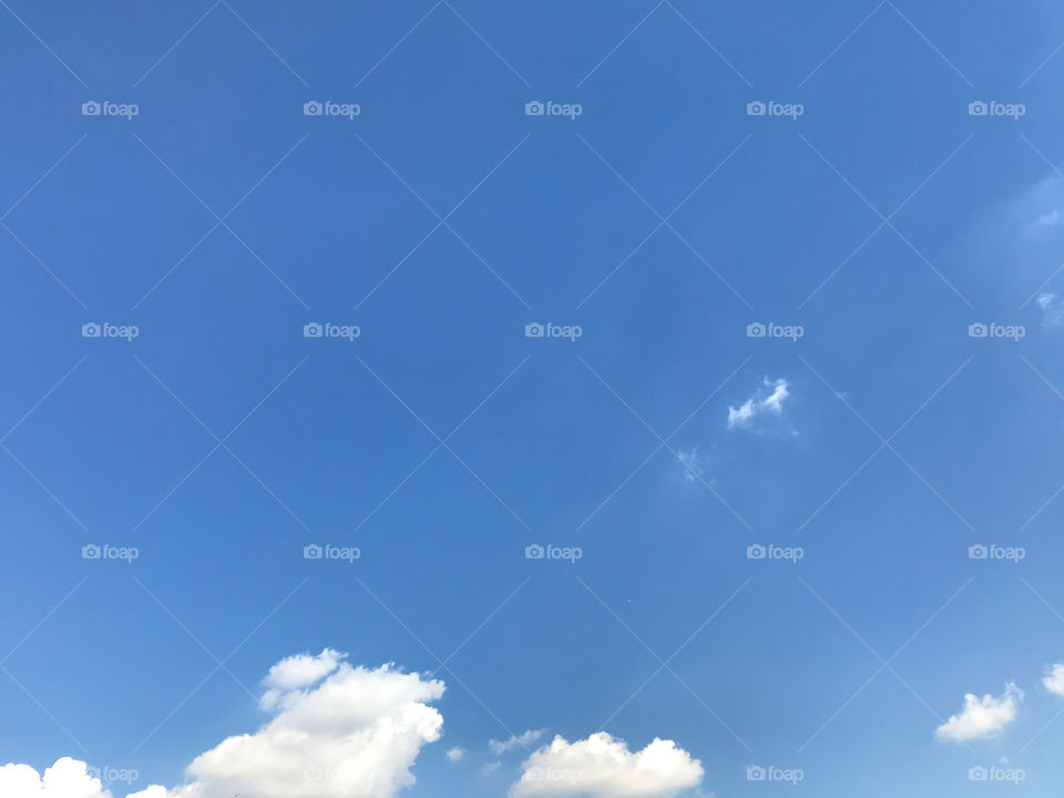 white clouds at the bottom of frame with bright blue summer sky in Tokyo, Japan, using for background