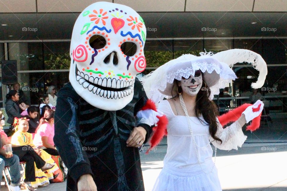 Man and woman dressed up as Day of the Dead characters during a Día de los Muertos Festival in the fall