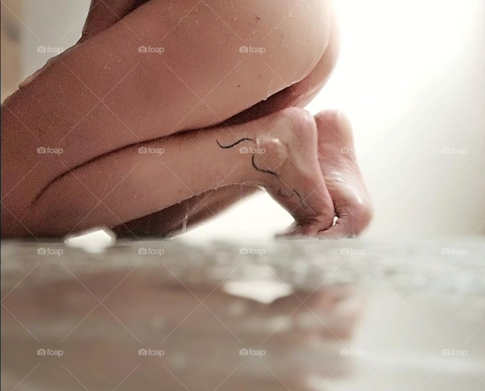 The water running down the woman's body at bath time exalts her curves, making the moment unique and very sensual.