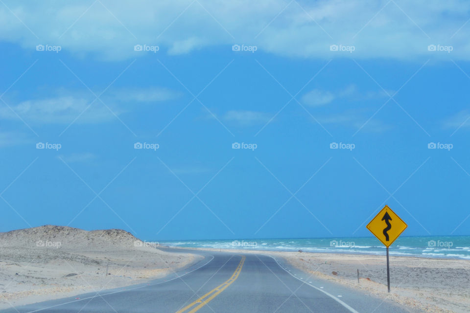 Road at the beach with signal curve