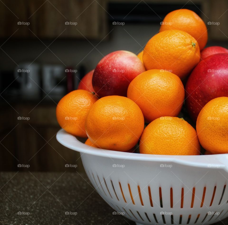 a basket of orange and apples