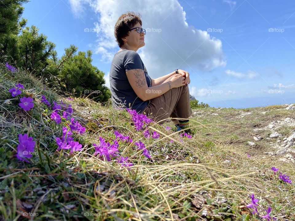 Portrait of young happy beautiful woman in Alps mountains close up.