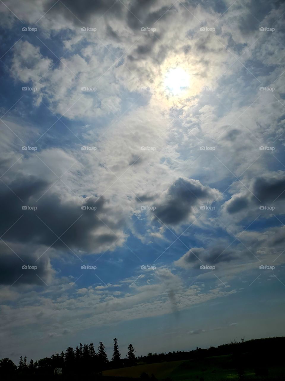 sun behind the clouds