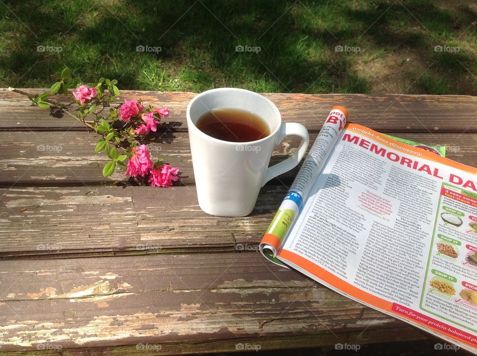 Enjoying a cup of coffee on a beautiful spring day outdoors.