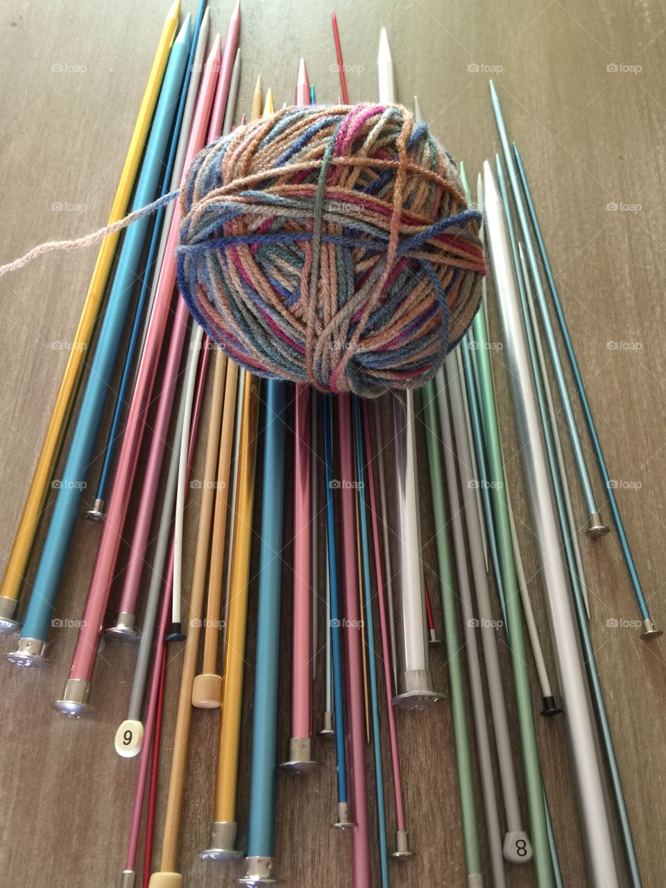 Knitting needles and yarn on table