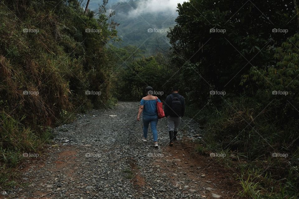 Two people entering the interior of the mountain as explorers. Exploring the virgin mountain