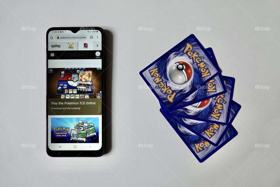 Back side of Pokemon cards and smartphone with PTCG. The Pokemon Trading Card Game is a collectible card game, based on Nintendo's Pokemon franchise.