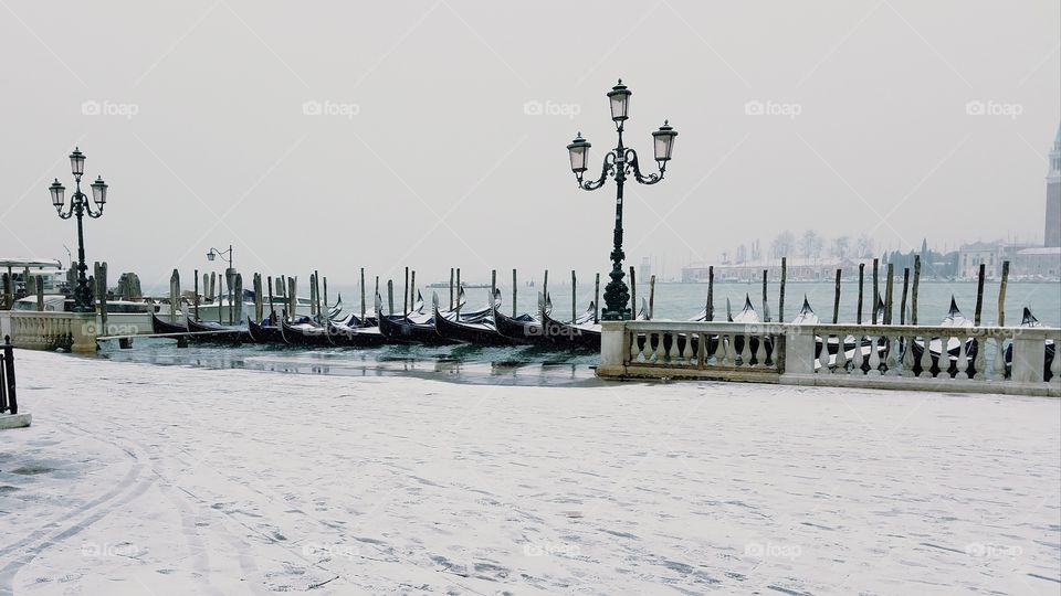 gondolas on a snowy day in Venice