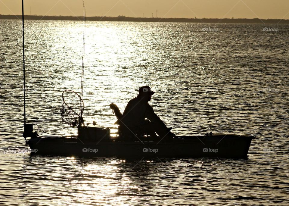 Man in kayak at sunset