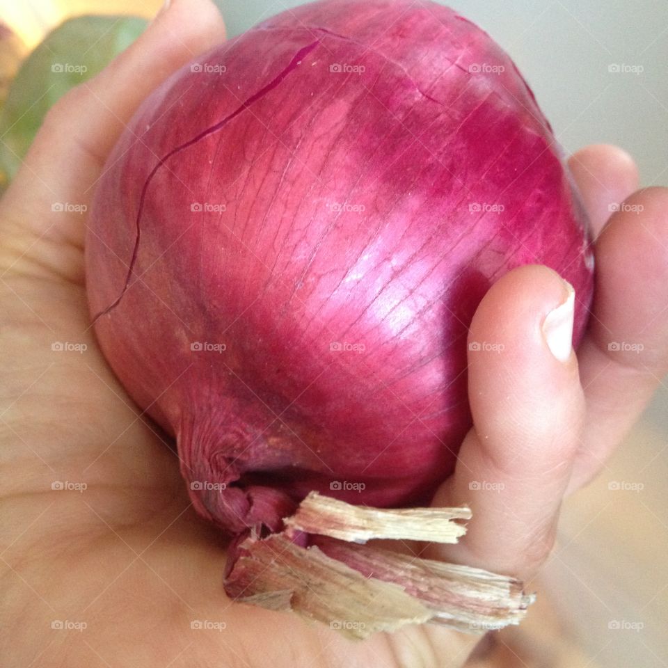 Holding red onion 