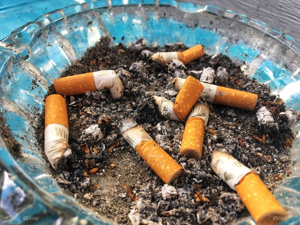 Cigarette butts in ash tray 