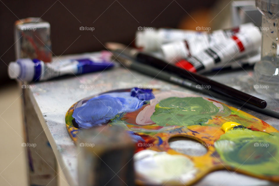 A palette and paints ready to be used by an artist in the studio