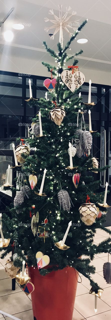 Beautiful Christmas tree with bright and beautiful ornaments decorated and standing in the front entrance of the mall. USA, America
