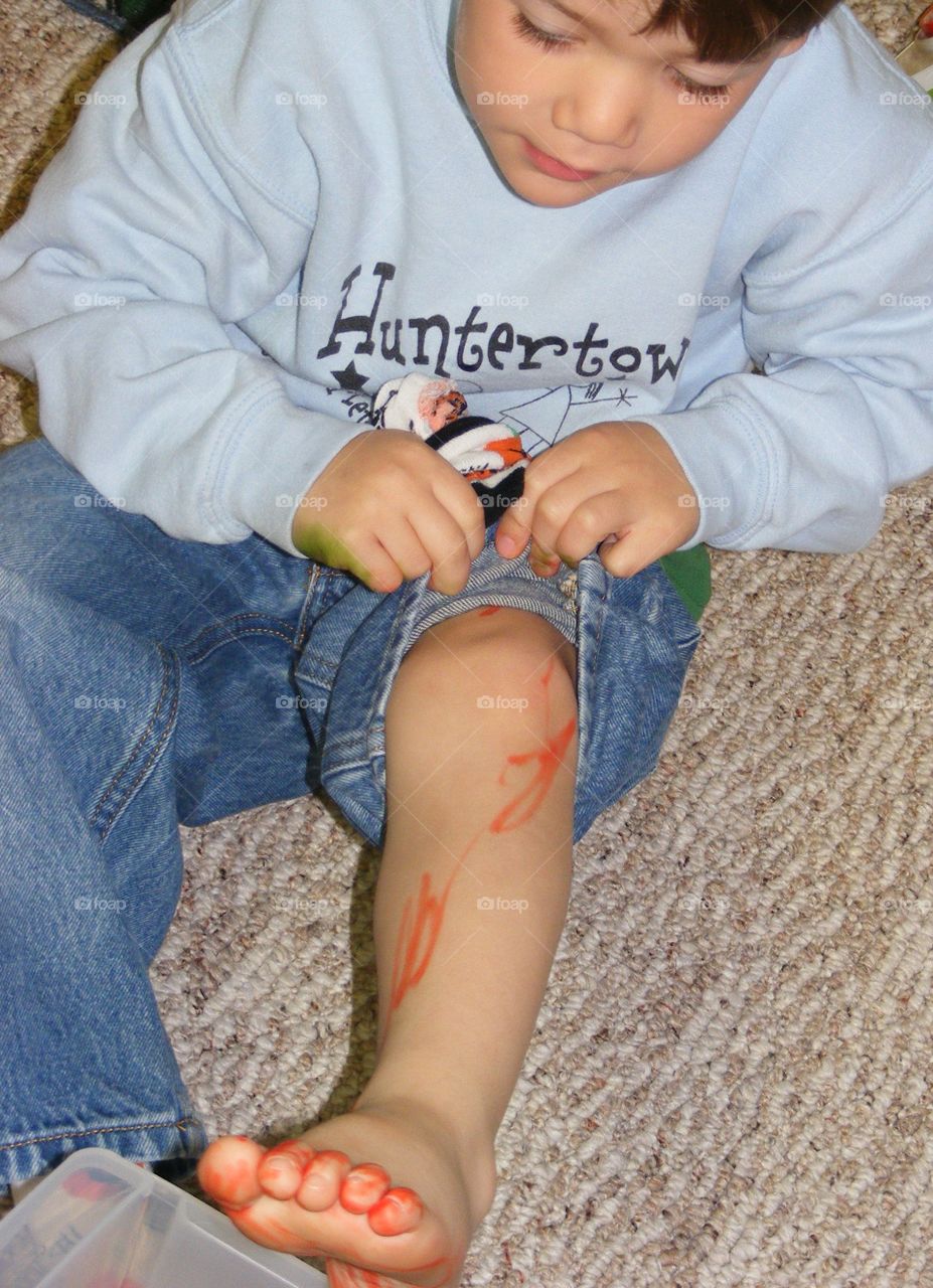 This boy colored his leg with markers .