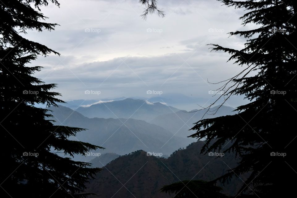 A Cloudy Morning. the mountains appearing as they are blanketed by the clouds creating a mesmerising scenery