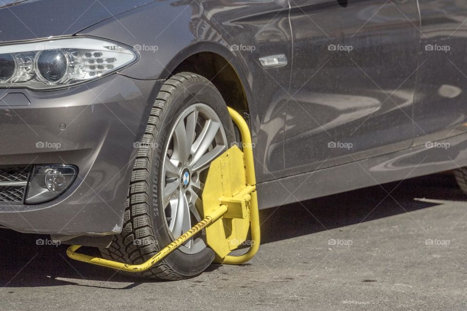 Improperly parked car with a wheel clamp
