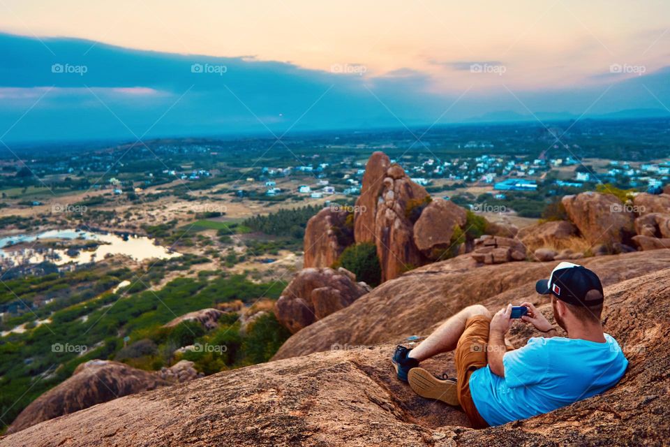 A man filming a sunset view - Mountain - Sitting 