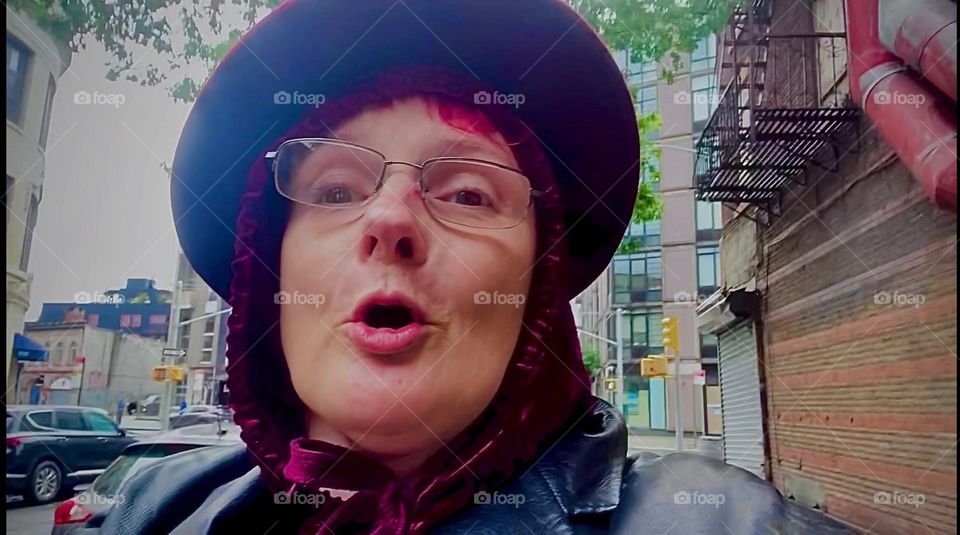 Hamming it up for the camera, this is me, “Petra Schiller” a.k.a. “Maxine Firefox” a.k.a. “Maximiliane Feuerfuchs” on “Waverly Av” off “Fulton St” in “Clinton Hill”, Brooklyn. 2023. Hypnotic Productions