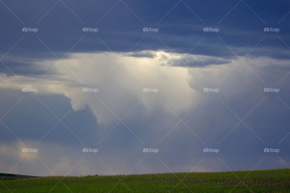 Rain on the Plains - rain clouds on the horizon in a rural area