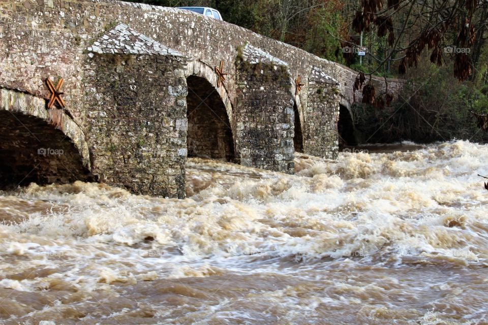 Bickleigh bridge channeling the  rising waters of the River Exe