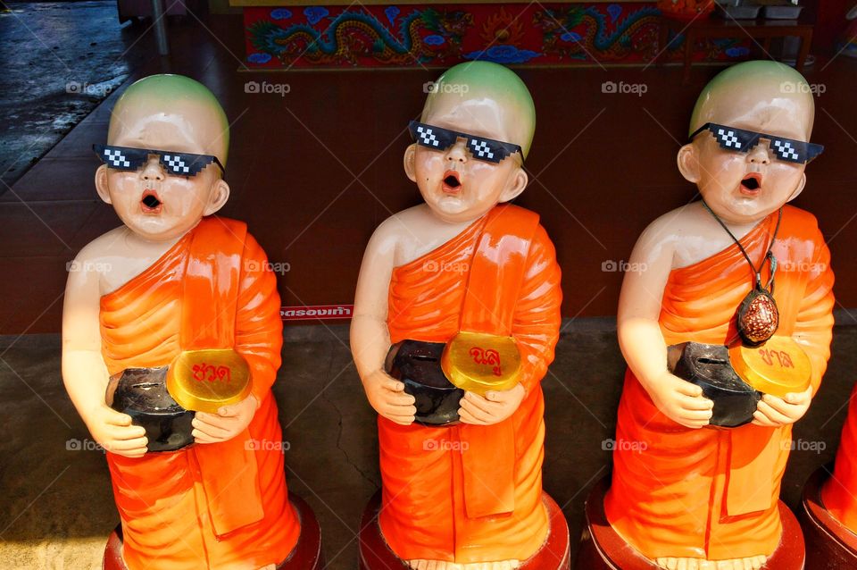 monks statue wearing glasses in thailand.