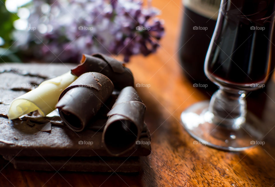 Vintage Port Wine and Dark Chocolate with cookie and curls of dark and white chocolate with lilac flowers conceptual wine tasting epicure gourmet lifestyle food photography background 