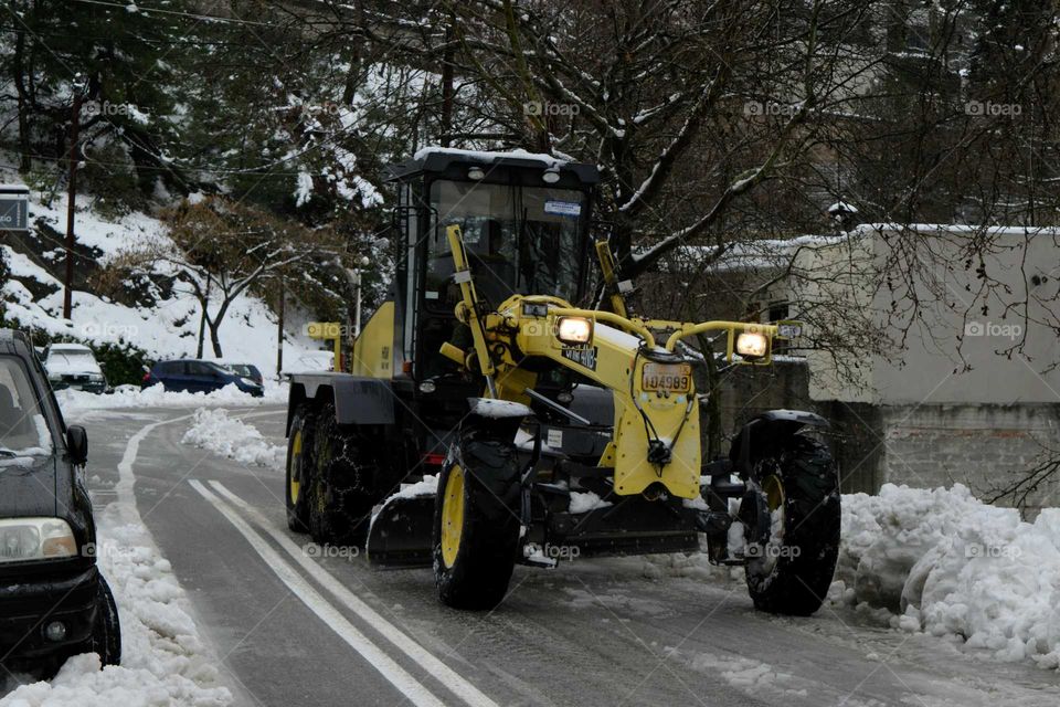 Machine cleaning road from snow