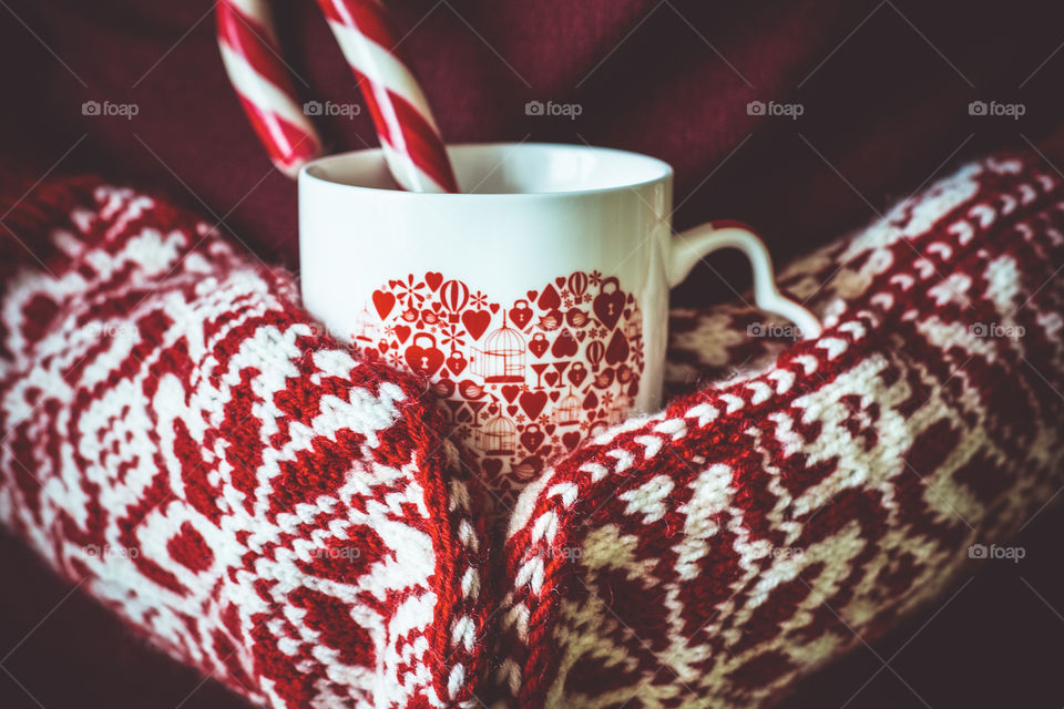 Hands in slaves holding cup of hot chocolate