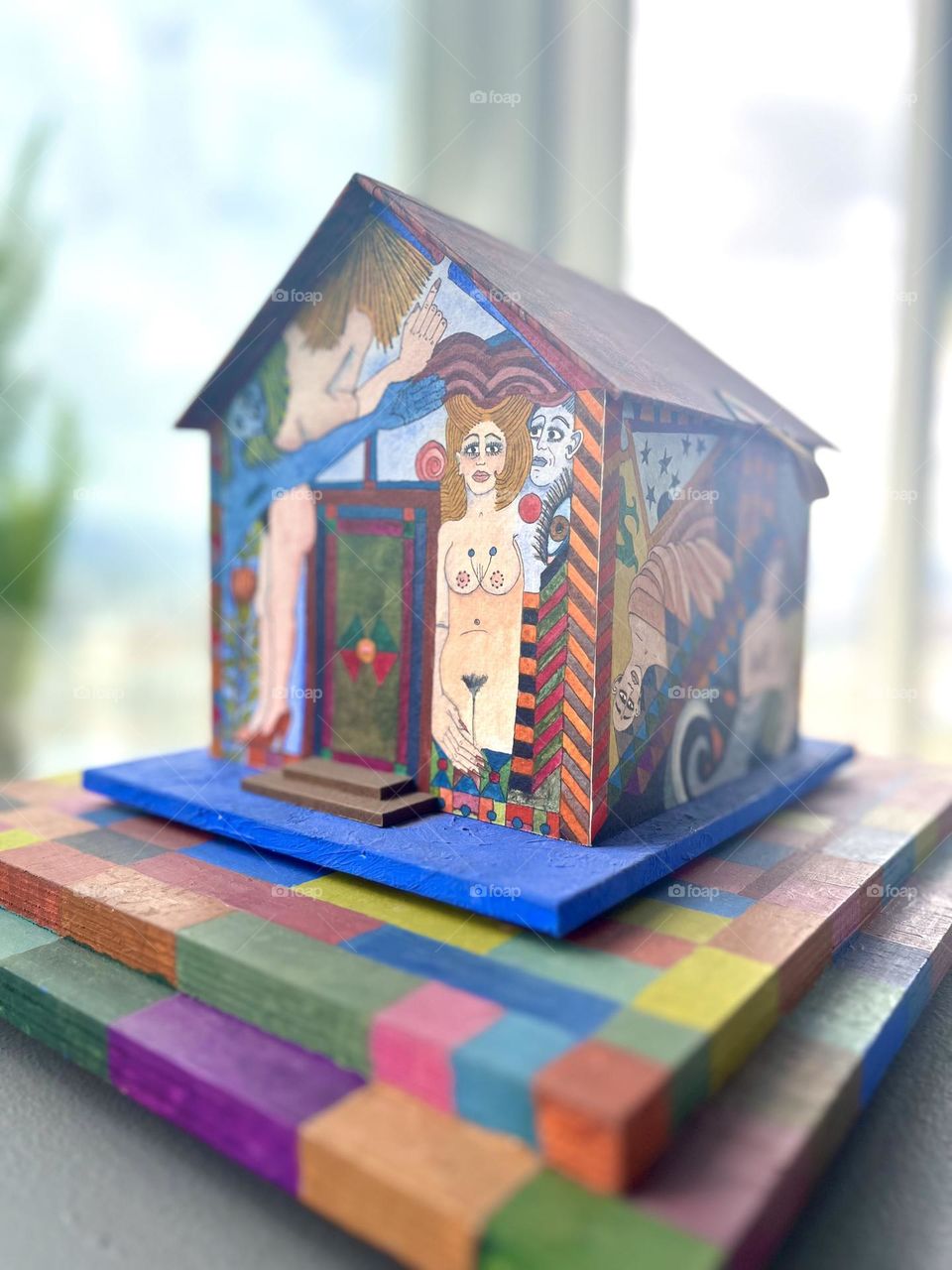 A naked woman in a triangle house