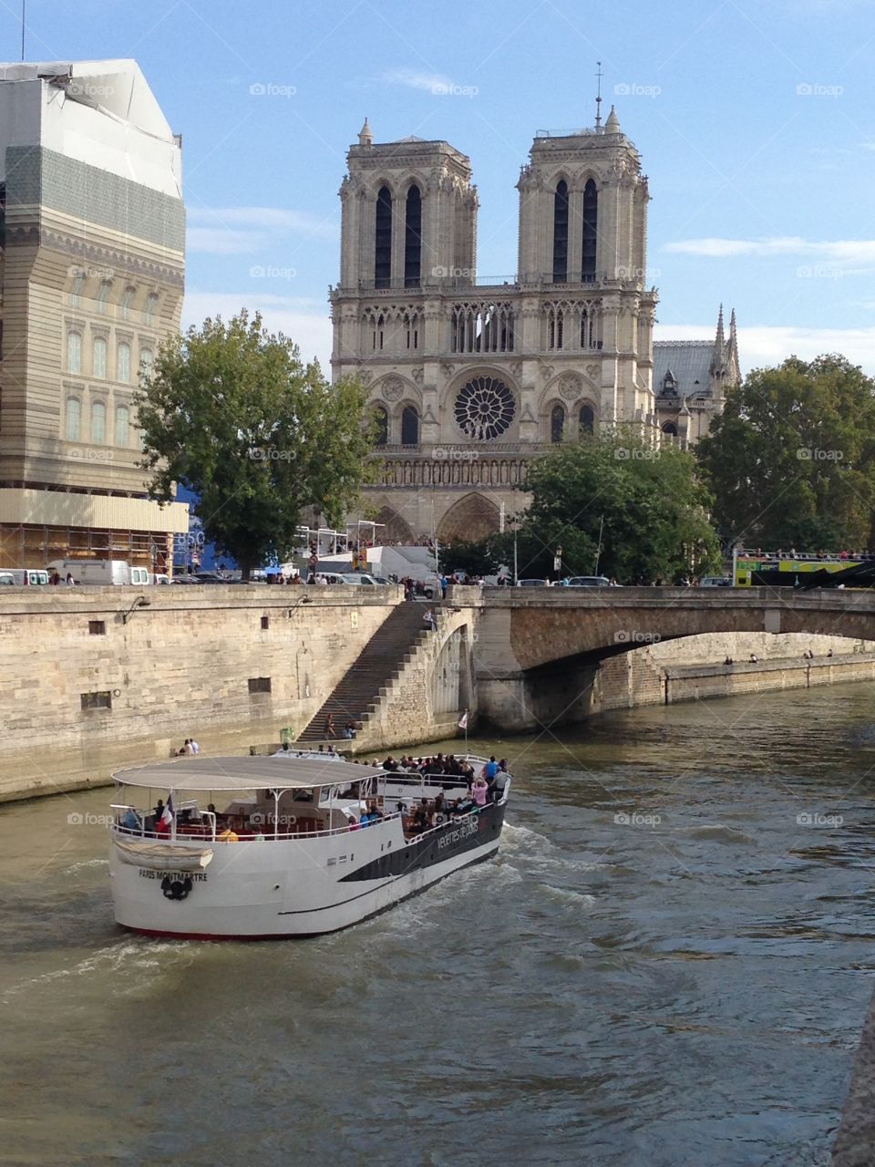Notre Dame cathedral across the Seine River, with tour boat. 
