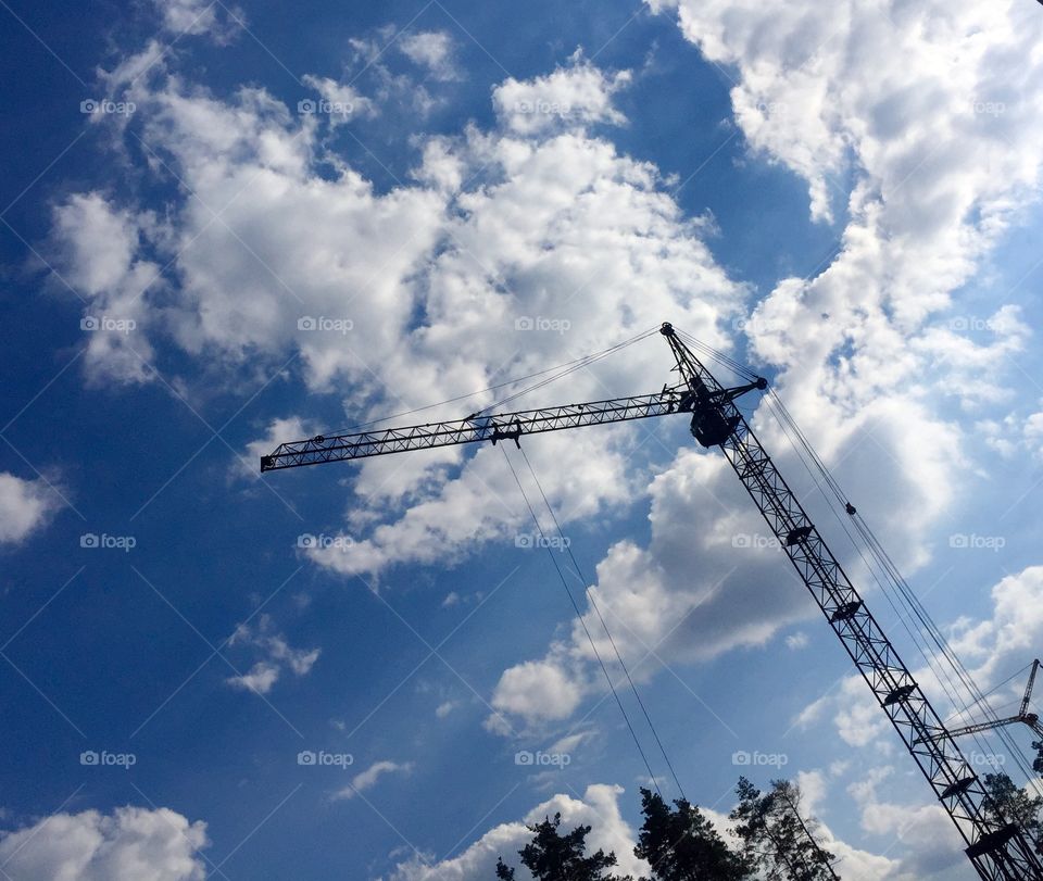 Construction crane against cloudy sky