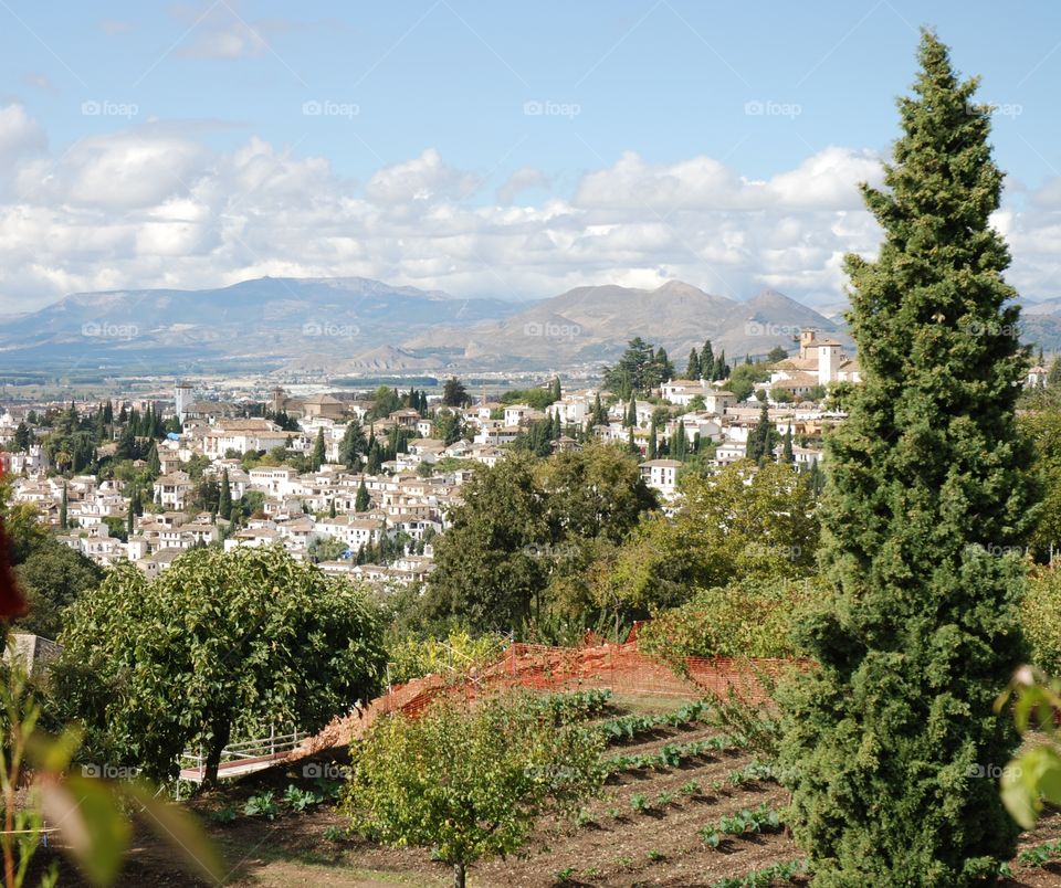 A view of the white ancient city of Granada from the gardens of the Alhambra