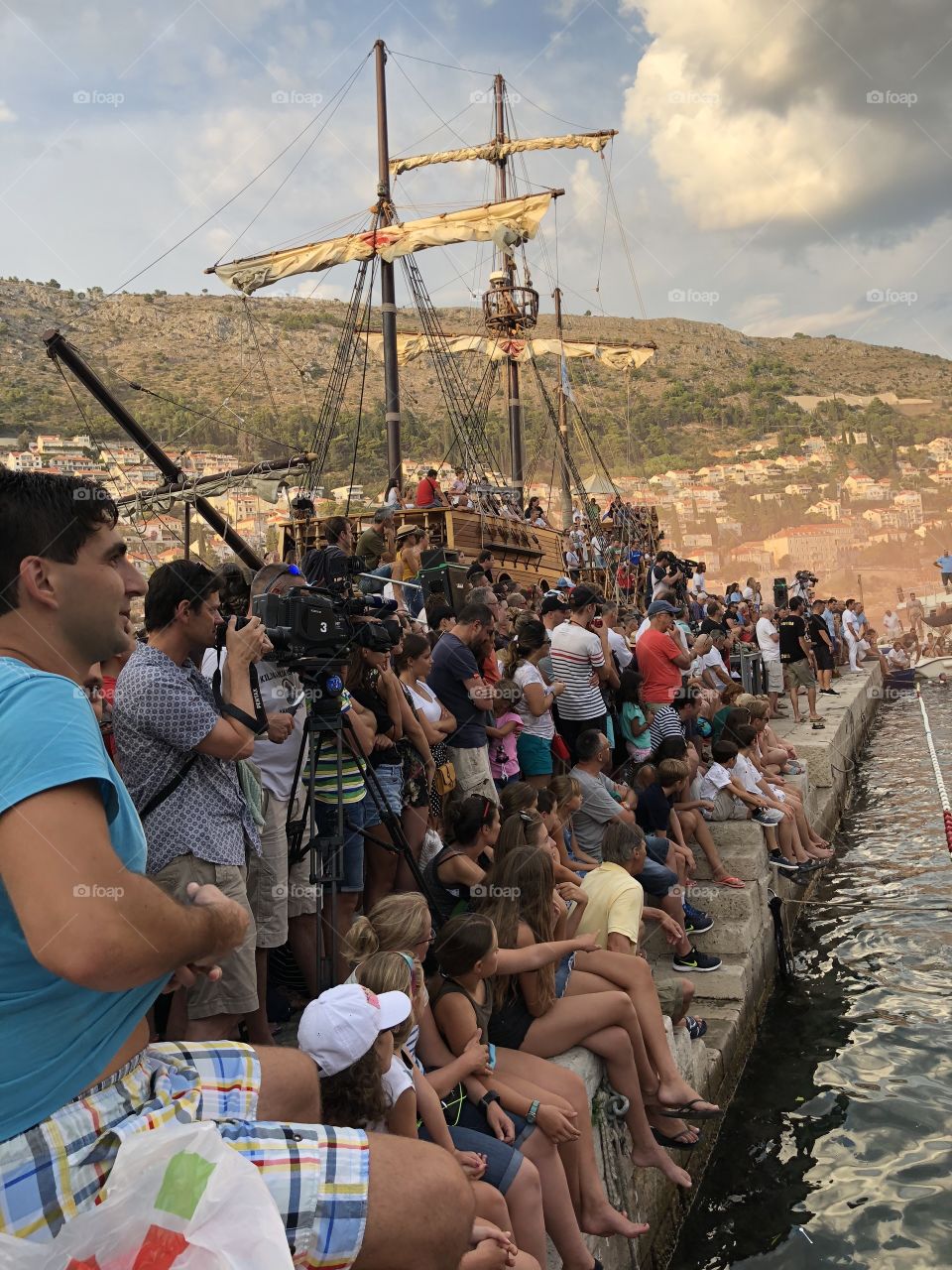 This is a picture of extremely enthusiastic fans during a water polo game in the old Harbour In Dubrovnik Croatia